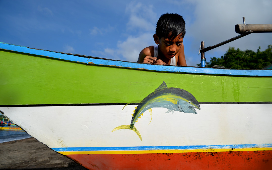 Kid in fisher boat