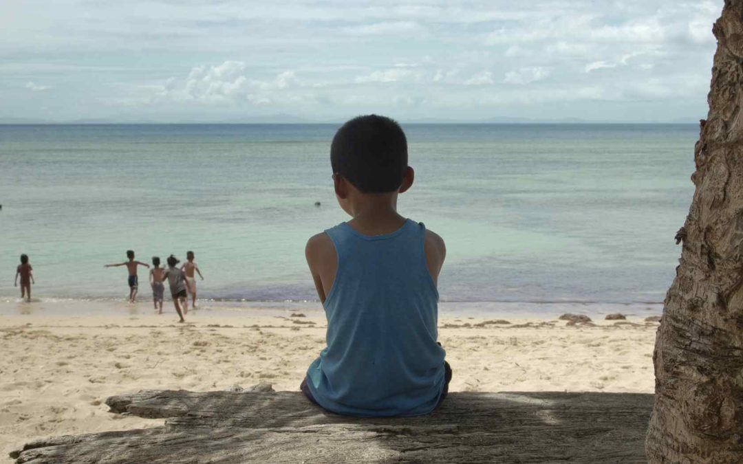 Nonoy sits alone on the beach