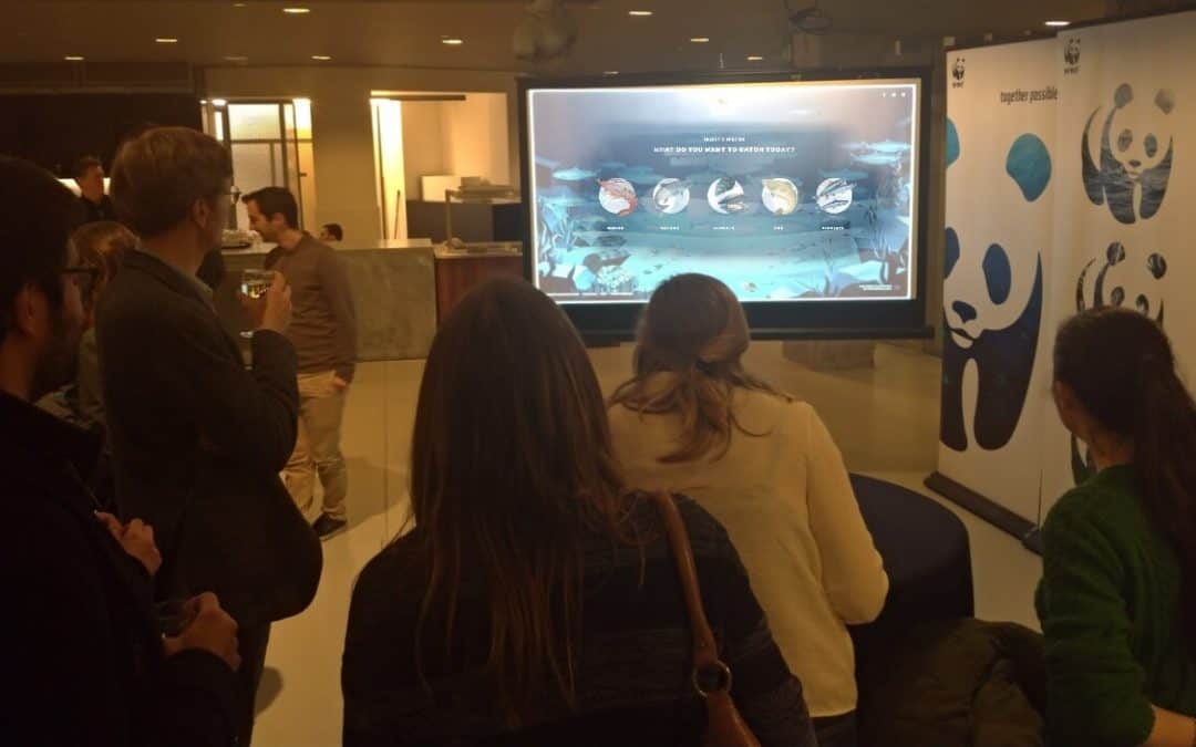 people attending WWF event in Brussels and playing the WWF finprint game on a big screen